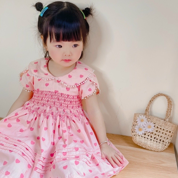 Child model wearing smocking dress from K-Embroidery